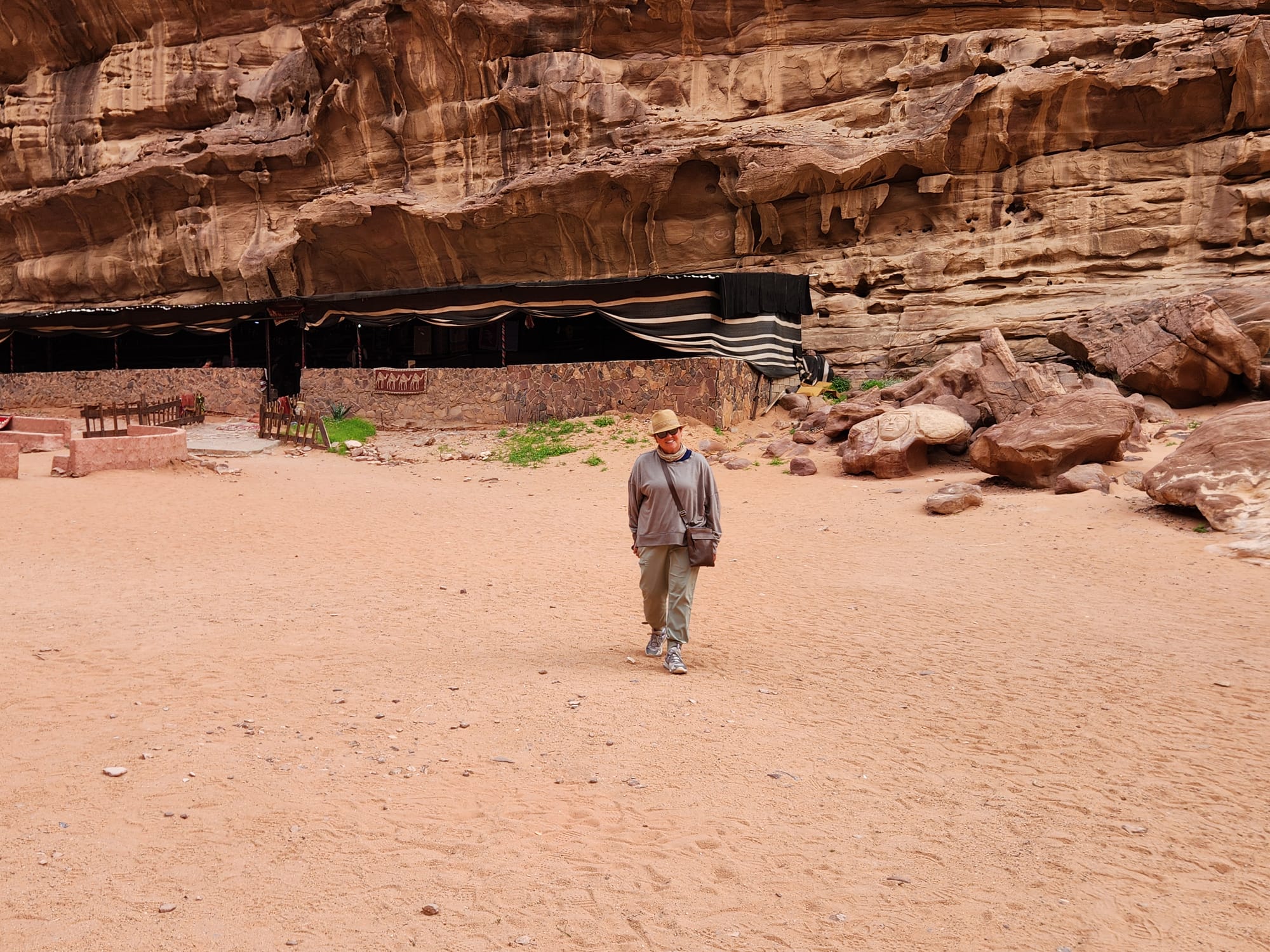 Tiffany Watt walking across the red sand at a Bedouin camp in Wadi Rum, Jordan