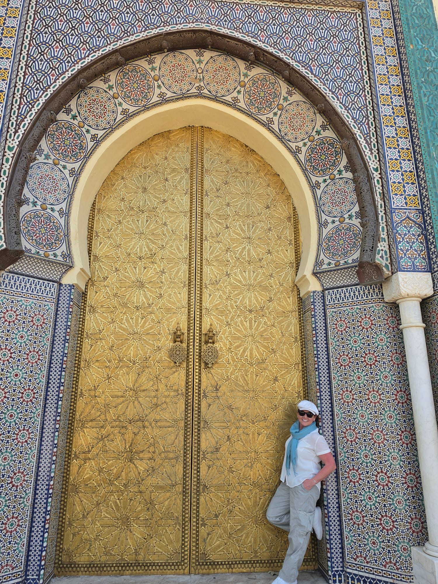 Tiffany Watt at the ornate golden door of the Royal Palace in Fez, Morocco