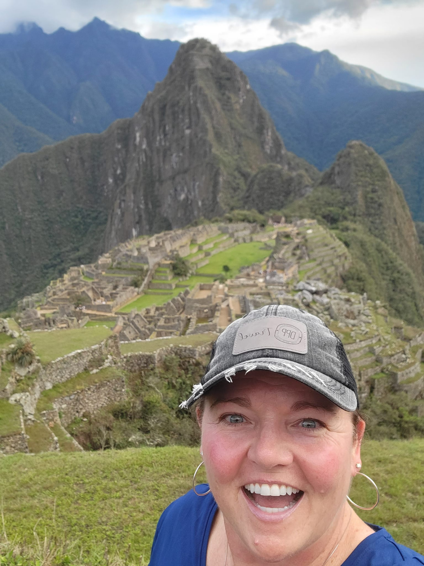 Tiffany Watt at Machu Picchu with the ancient citadel and Huayna Picchu rising behind her, Peru