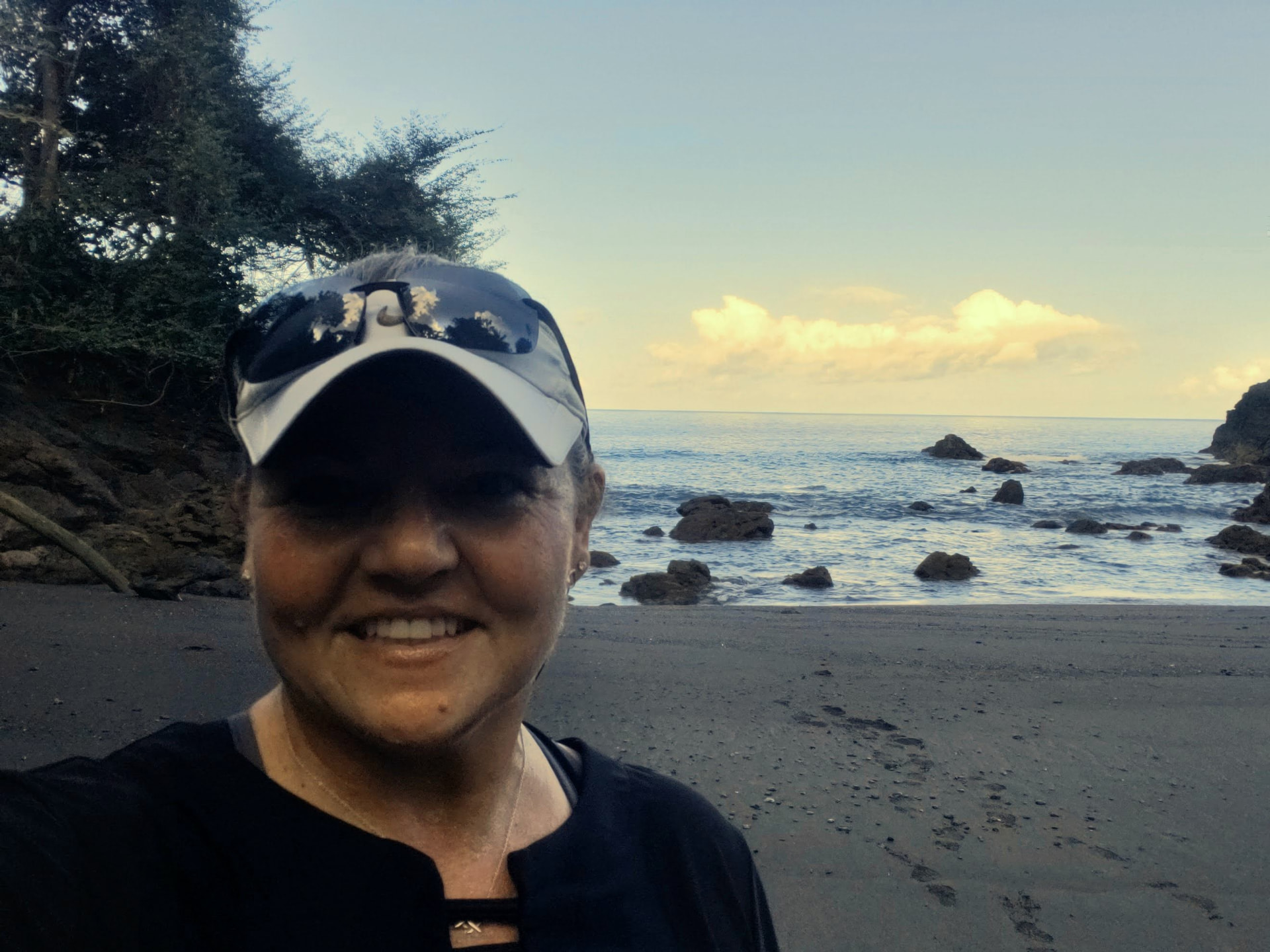 Tiffany Watt on a black sand beach on the Pacific coast of Costa Rica at sunset